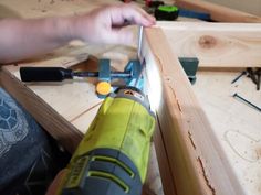 a person working with wood and tools on a table