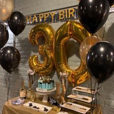 an image of a birthday party with gold and black balloons that say happy birthday to the 30 year old