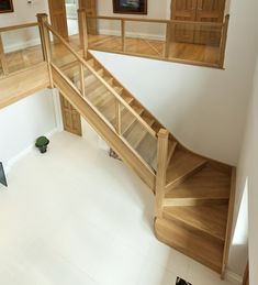 an overhead view of a wooden staircase in a house