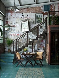 an image of a room with stairs and tables