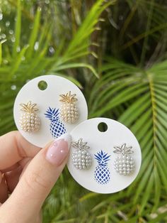 Our top-selling pineapple earrings, a fan favorite! These gorgeous pineapple stud earrings are available in your choice of gold or silver, and feature a fun pop of texture with raised pearl detailing. Classy and chic, these pearl pineapple earrings are a must-have for any preppy girl’s jewelry box. They’re perfect for everyday wear, or for adding a touch of glam to any outfit. They also make a fabulous gift! Measures 3/4" tall Goldtone and pearl or silvertone and pearl Top post Luxury Summer Earrings For Gift, Shell-shaped Pearl Earrings For Summer Gifts, Summer Gift Pearl Earrings Shell-shaped, Shell-shaped Pearl Earrings For Summer Beach, Pineapple Related Gifts, Pineapple Lover Gifts, Pineapple Island Jewellery, Pineapple Jewelry Bracelets, Pearl Top