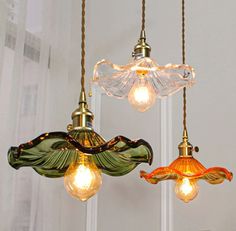 three glass lights hanging from the ceiling