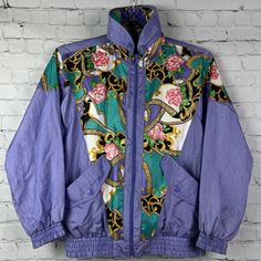 Vintage 1993 Sunterra Windbreaker Track Jacket Purple Flower Gold Petite Womens. Welcome To Project Perseverance! Brand: Sunterra Size: Ps Condition: Excellent Vintage Pre-Owned Condition Color/Pattern: Nice Light Purple Color With Gold And Floral Pattern. In Great Condition. No Shoulder Pads. Measurements: - Pit To Pit (Across Chest):~ 21” - Length (Top Of Collar To Hem):~25 ” -Sleeve (Shoulder To Cuff): ~ 26.5“ Thank You For Shopping With Project Perseverance! Condition Notes And Buying Proced Retro Long Sleeve Windbreaker For Spring, Retro Long Sleeve Spring Windbreaker, 90s Spring Outerwear, Retro Floral Print Winter Outerwear, Vintage Fitted Windbreaker For Fall, 90s Style Multicolor Windbreaker For Spring, Fitted Vintage Windbreaker For Fall, Vintage Fitted Long Sleeve Windbreaker, 90s Style Long Sleeve Spring Outerwear