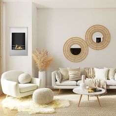 a living room filled with white furniture and pillows on top of a rug covered floor