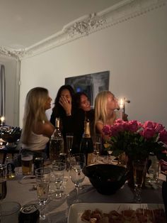 a group of women sitting around a dinner table