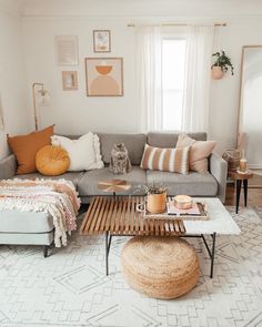 a living room filled with lots of furniture and pillows on top of it's couches