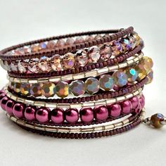 a stack of bracelets with pink and purple beads