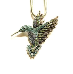 "Unique gift necklace brooch two in one, jewelry for women - Hummingbirds. Silver colored metal hummer profusely studded with blue and clear miniature crystals. Pendant brooch 2in1, size diameter: 2\" / 5 cm Silver colored chain: 19\" (+2\") / 48 cm (+5 cm)  Hummingbirds earrings: https://www.etsy.com/de-en/listing/1126436280 For ASAP - please ask in advance! Delivery time is separate and depends on the destination, for urgent delivery choose \"Delivery upgrades\" and leave phone! Please take a Costume Jewelry Brooch For Gift, Silver Jewelry With Large Pendant For Party, Costume Jewelry Gift With Lobster Clasp, Unique Brooch Jewelry As A Gift, Silver Costume Jewelry Brooch, Round Brooch Jewelry Gift, Unique Metal Jewelry Brooch, Unique Metal Brooch, Green Sterling Silver Brooch Jewelry