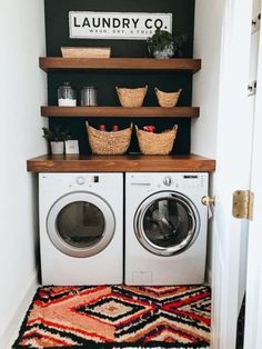 a washer and dryer in a laundry room with shelves above them that have baskets on top