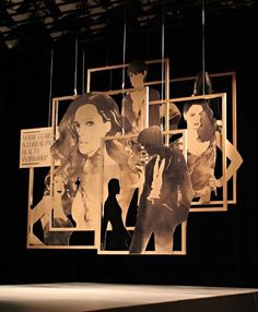 an artistic display with multiple photos hanging from it's sides and people in silhouettes on the wall