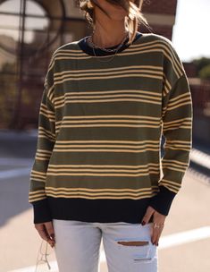 Get ready to harvest some compliments with our Harvest Stripes Sweater. Perfect for casual cute style, this sweater will keep you cozy while adding a touch of playful charm to your look. Ready to wear to your next pumpkin patch adventure or cozy night in. (Sweaters look good on pumpkins too!) Fabric 50% rayon, 28% nylon, 22% polyester Cozy Striped Sweater For Fall, Trendy Green Fall Sweater, Fall Sweater For Casual Gatherings, Trendy Striped Sweater For Fall, Cozy Sweater For Casual Winter Gatherings, Cozy Winter Sweater For Casual Gatherings, Retro Fall Layering Tops, Fall Sweater With Ribbed Crew Neck, Fall Crew Neck Sweater With Ribbed Neckline