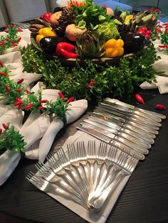 a table topped with lots of different types of food and silverware on top of it