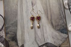 Beautiful handmade Antique Gothic Victorian detailed hands in 14K polished brass finish hanging from antiqued faceted ruby red hearts. Mounted on an antiqued brass French fish hook wires. Measurements: approx. 2" Gothic Antique, Earrings Gothic, Ruby Heart, Gothic Victorian, Heart Hands, Red Hearts, Fish Hook, Ruby Red, Polished Brass