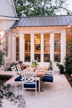 an outdoor dining area with table and chairs