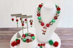 "Made with a cute rhinestone pendant featuring the big jolly guy himself, Santa! A festive Christmas palette of red and green is the perfect finishing touch for a Christmas outfit. Makes a great stocking stuffer or Christmas present. Includes a special \"Santa's Belt\" bead. Matching earrings are available in my Christmas section. Visit my Christmas section for more festive necklaces: https://www.etsy.com/shop/ChunkyStuffByLBB?section_id=16141299&ref=shopsection_leftnav_5 ✔ Necklaces come in Red Jewelry For Christmas Birthday, Christmas Beaded Necklaces, Christmas Palette, Santa Belts, Festival Necklace, Christmas Necklace, Chunky Statement Necklace, Chunky Bracelets, Winter Party