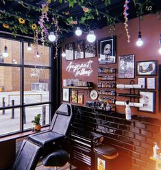 a barber shop with lots of flowers hanging from the ceiling and lights on the wall