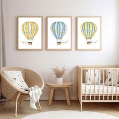 a baby's room with two hot air balloons on the wall