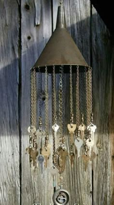 an old fashioned wind chime hanging from a wooden wall