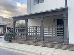 a white building with a black gate on the outside