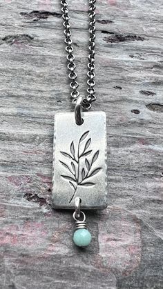 A tiny genuine birthstone has been wrapped in sterling silver. The natural gemstone dangles from a small silver rectangular pendant. I have cut the rectangle from a sheet of solid sterling silver. I then stamped a branch into the center of the pendant and lightly hammered the border. The pendant hangs from a sterling silver chain which features a lobster claw clasp and a 3-inch extender allowing the chain to be slightly adjustable.Be sure to see all photos and video for size and color reference. Color Reference, Patina Finish, Green Peridot, Personalized Birthday Gifts, Birthstone Necklace, Chain Ring, Silver Jewellery, Lobster Claw, Sterling Silver Chains