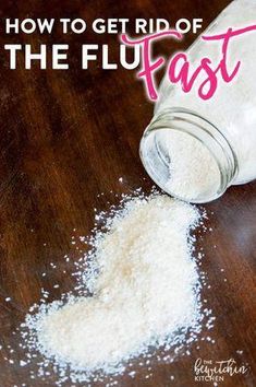 a bottle filled with white powder sitting on top of a wooden table next to a pile of salt