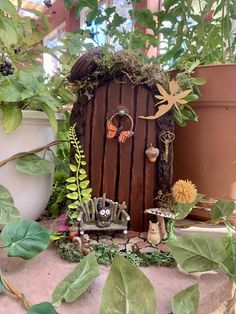 a fairy door surrounded by plants and flowers