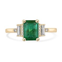 an emerald and diamond ring with three baguets in yellow gold plated silver