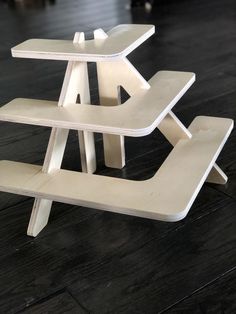 a white table with two benches on top of it