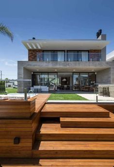 a modern house with wooden steps leading up to it