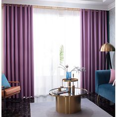 a living room with purple curtains and blue couches