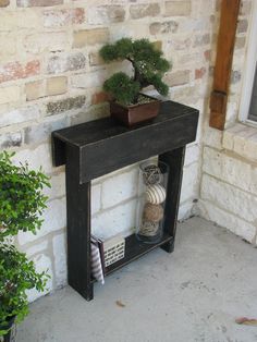 a potted plant sitting on top of a wooden shelf next to a brick wall