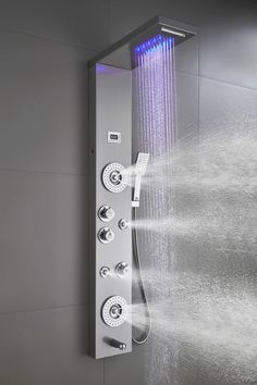 a shower head with water coming out of it's side and rainbow lights in the back