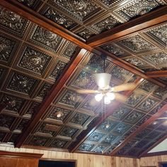 the ceiling in this room is made of wood and has intricately designed tining