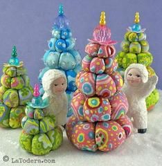 some very cute little christmas trees with sheep