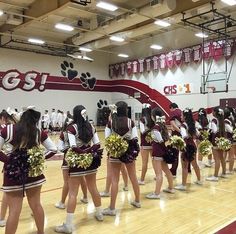 a group of cheerleaders standing on top of a basketball court