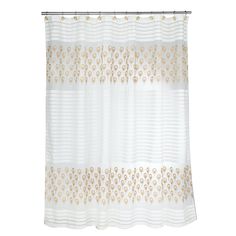 a white shower curtain with gold circles on it's side and an attached rod