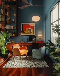 a living room with blue walls and wooden flooring, two chairs in front of a large window