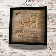 a scrabbled wooden frame with the words family on it