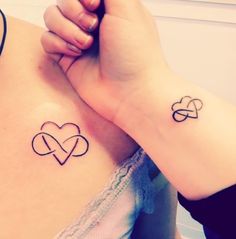 two tattoos on the back of women's bodies, one with an intertwined heart