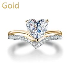 a heart shaped diamond ring with rose gold band and diamonds on the side, in front of