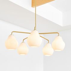 five lights hanging from a ceiling in a room