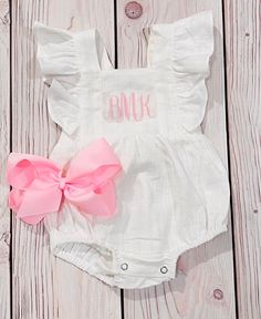 This listing is for a cute white linen personalized romper. This fabric is one of my favorites and so soft and perfect for summer.  This comes with a vinyl personalized name or you can choose to have monogram initials.  Please note this is done in vinyl Made from an organic linen fabric.  Featured adjustable straps in the back with 2 buttons so your little one has room to grow and the romper will last longer.  Straps have cute ruffles Spring White Bubble Romper For Beach, White Spring Bubble Romper For Beach, White Summer Bubble Romper For Beach, Cute White Jumpsuit For The Beach, White Ruffle Bubble Romper For Summer, White Ruffled Bubble Romper For Summer, Summer White Bubble Romper With Ruffles, Summer White Ruffle Bubble Romper, White Summer Jumpsuits And Rompers With Ruffles