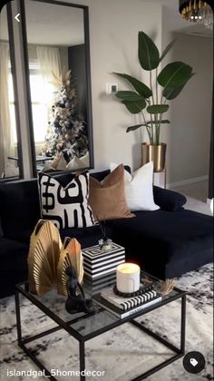 a living room filled with furniture and a large mirror on the wall above it's coffee table