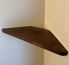 a wooden shelf hanging on the wall