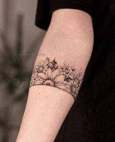 a woman's arm with flowers on it