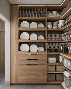 the shelves in this kitchen are filled with plates and bowls, cups and utensils