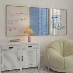 two paintings hang on the wall next to a white cabinet with drawers and a lamp