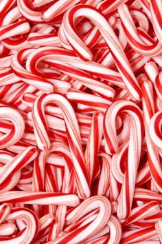 a red candy cane surrounded by silver and white spirals with the letter s on it