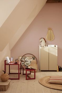 a room with pink walls and wooden floors