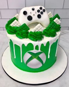 a green and white cake with a video game controller on top